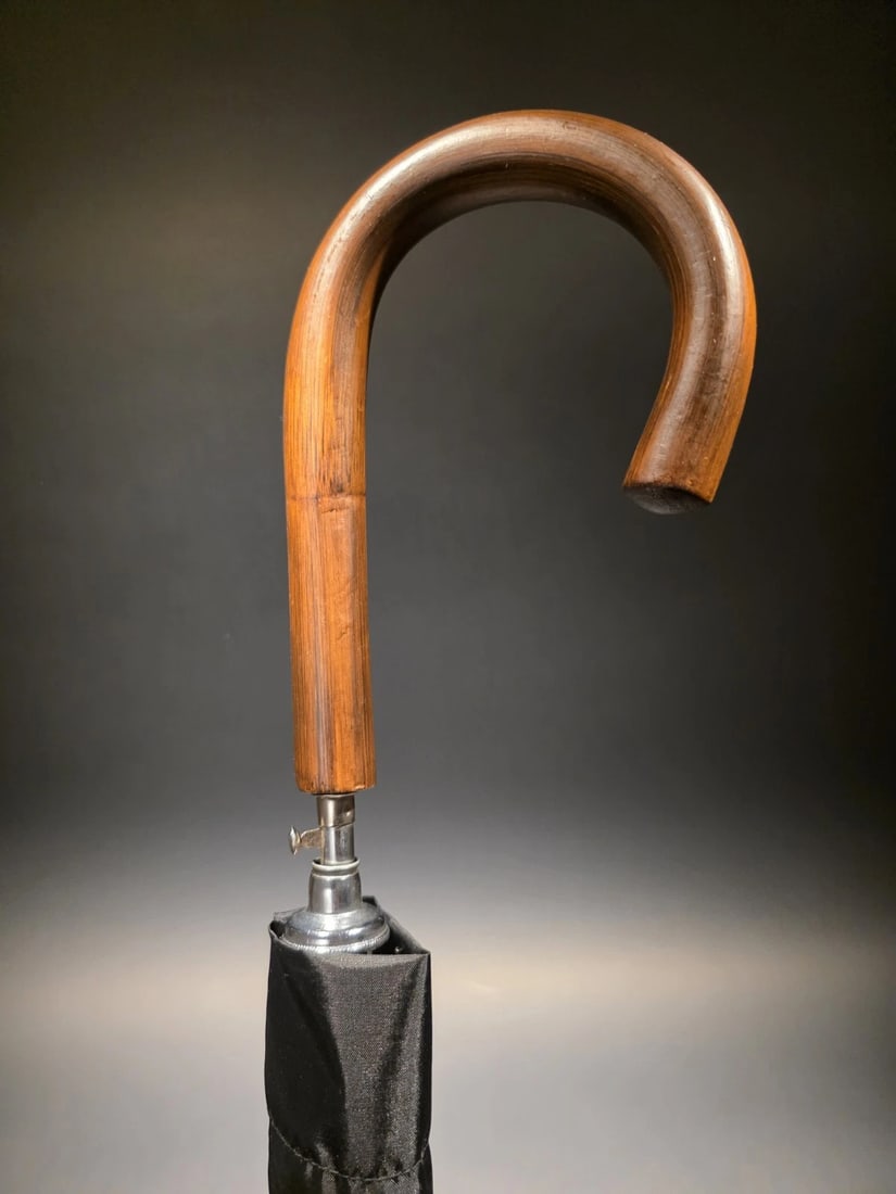 36" Wood Crook Umbrella: Wonderful new reproduction self opening umbrella with a dark hardwood crook handle. The umbrella is a 24" black nylon canopy with 8 ribs. 24X8X8. The umbrella measures 36" in length with a black nylon