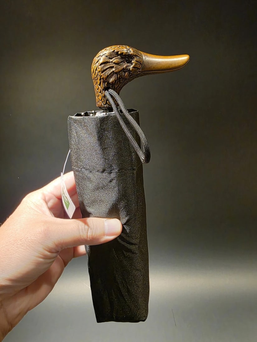 11 1/2" Mallard Duck Handle Umbrella: Mini black nylon folding umbrella, 8 ribs, 23" canopy, manual open. Comes with sheath and black wrist strap. Measures 11 1/2" when closed, weighs 10oz. The Concord Mallard Duck Handle Umbrella is a