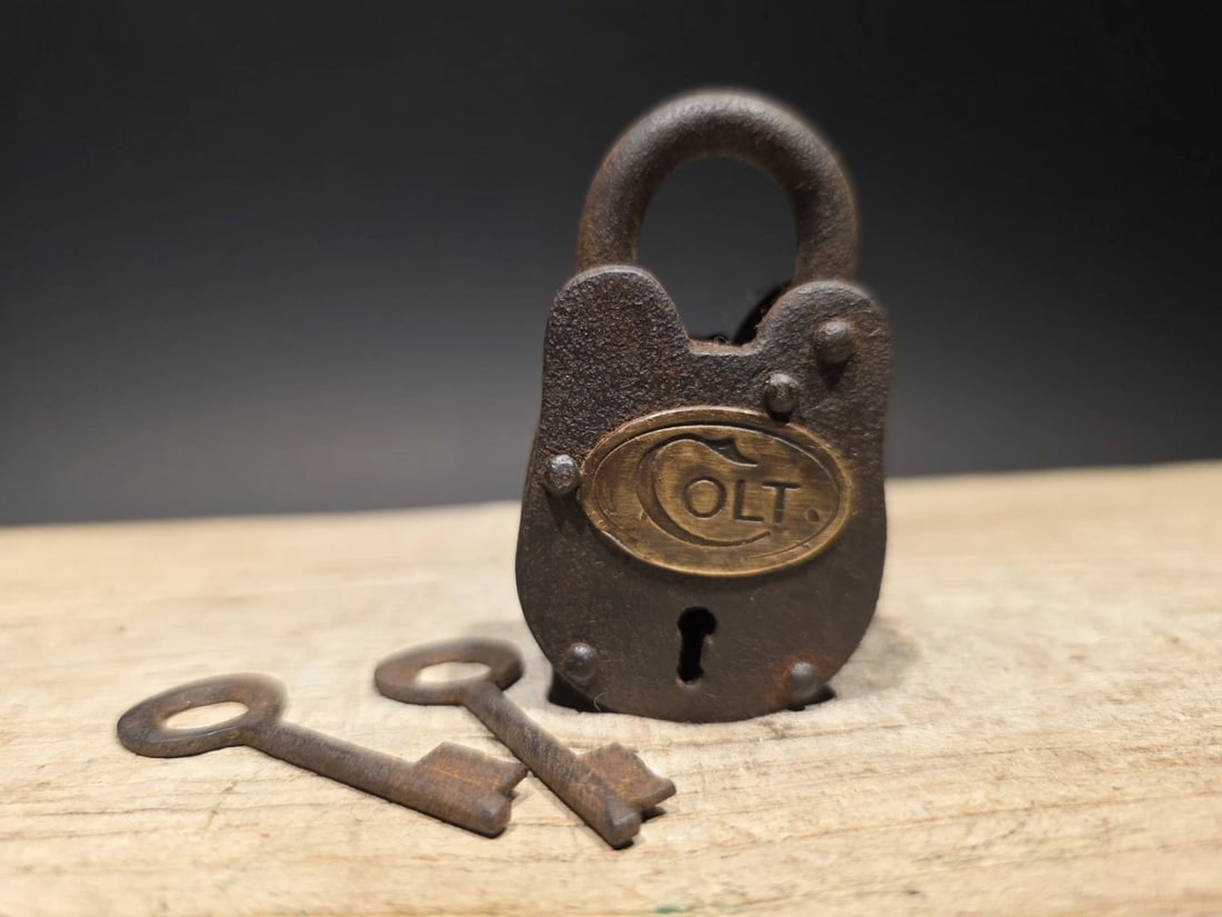 Cast Iron Colt Firearms Ammo Box Padlock Lock & Key: Nice reproduction cast iron Colt padlock! This lock is fully functional! Hard to tell its age. Heavy iron and brass. Great aged patina throughout. Limited quantity available! Reserve: $15.00
