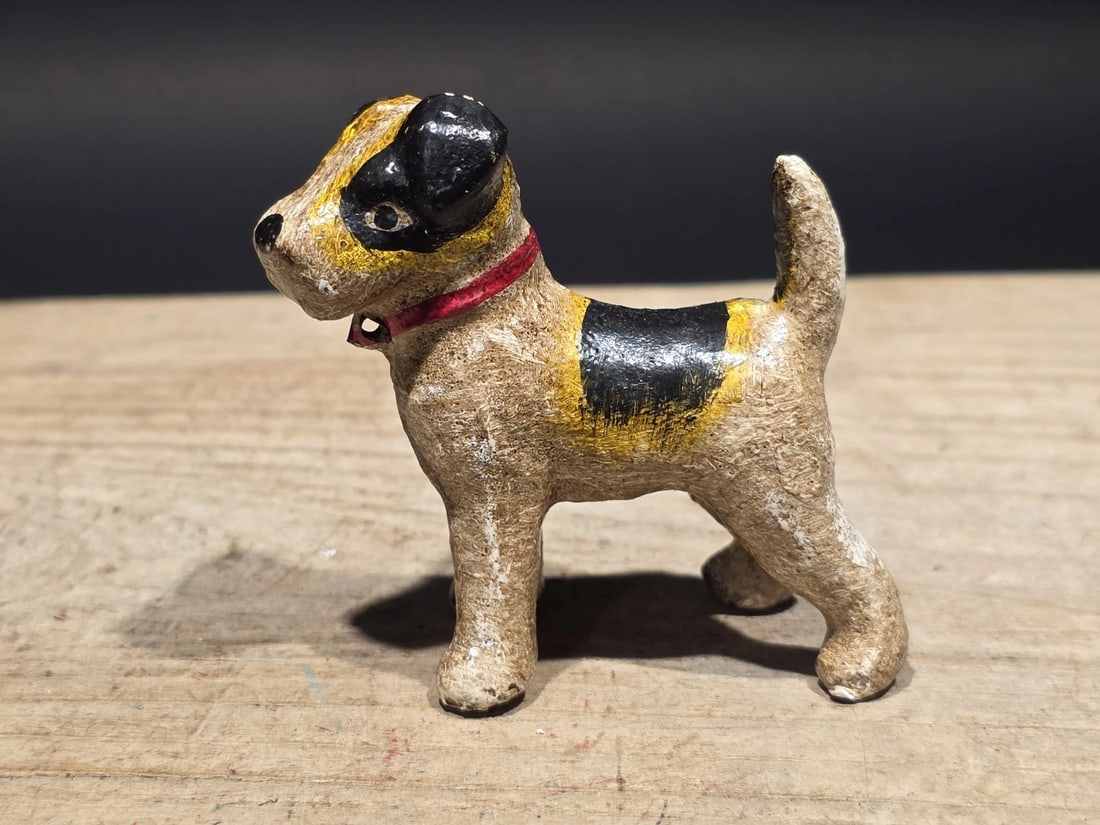 Miniature Cast Iron Fox Hair Terrier Dog: Small cast iron terrier dog figurine with hand-painted detailing. Terrier figures like this were popular decorative objects during the late 19th and early 20th centuries, when animal forms were