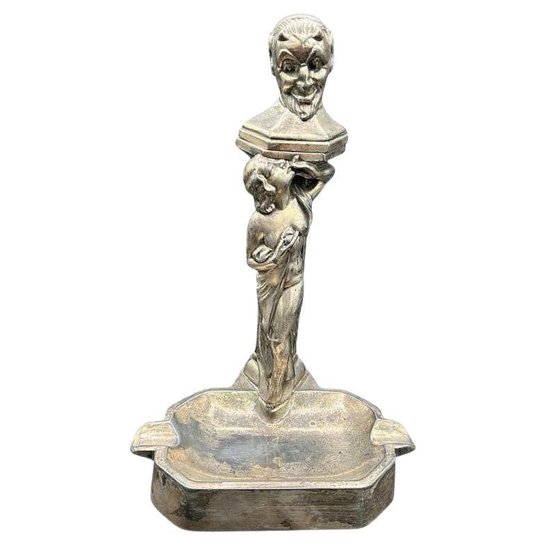 RARE Smoking Women w/ Temptation Devil Figurative Ashtray w/ Lighter: Title: RARE Smoking Women w/ Temptation Devil Figurative Ashtray w/ Lighter Description: This 1920s white metal table lighter and ashtray features a Devil/Satyr bust above a smoking nymph with her bar