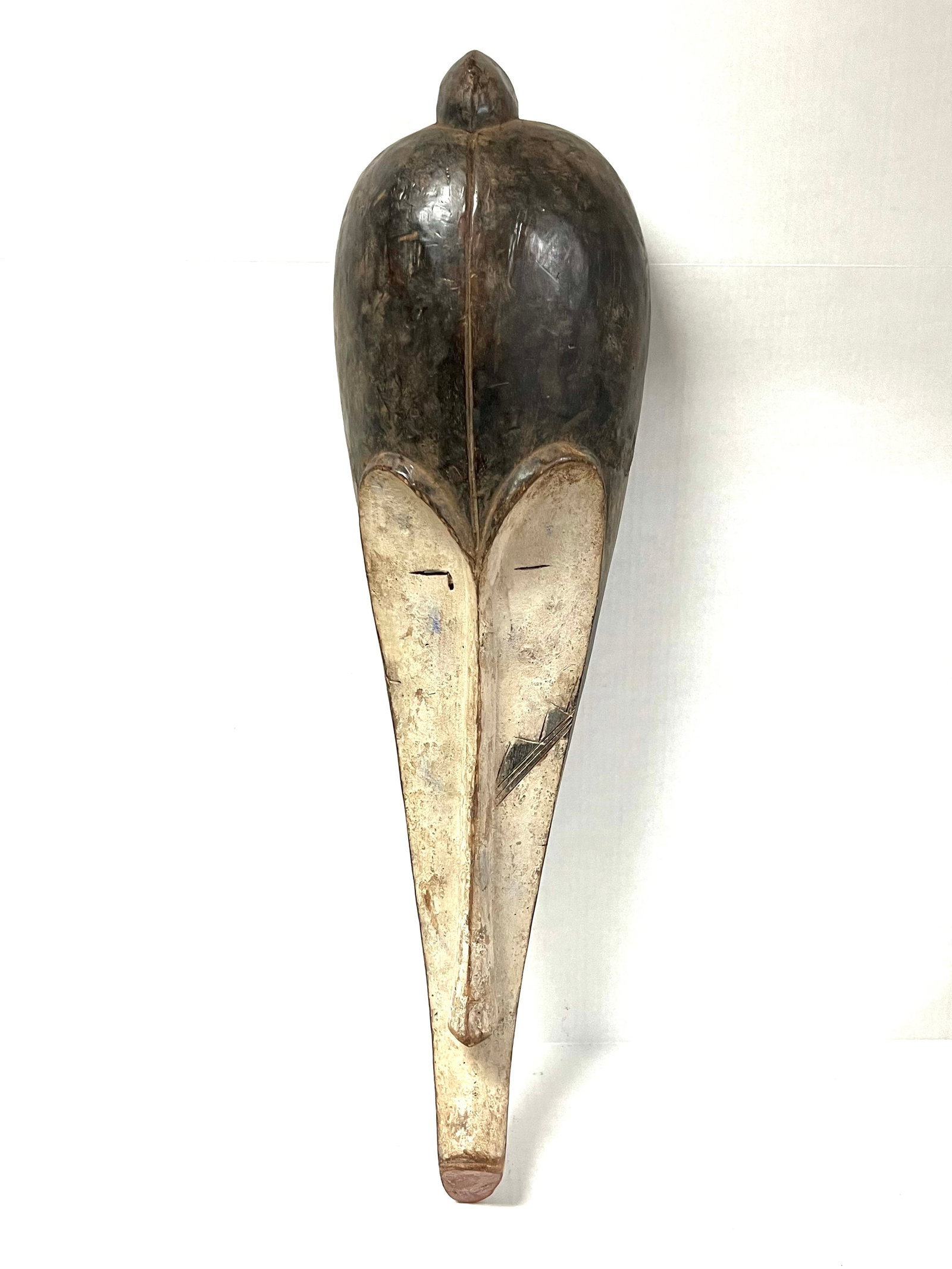 Fang Mask: Title: Fang Mask Description: African Tribal Art Carved Wood Fang Mask Materials: Wood Date/Period: Late 20th Century Size: 30" h x 8.5" w Reserve: $200.00 Shipping: Domestic: Flat-rate of $30.00 to