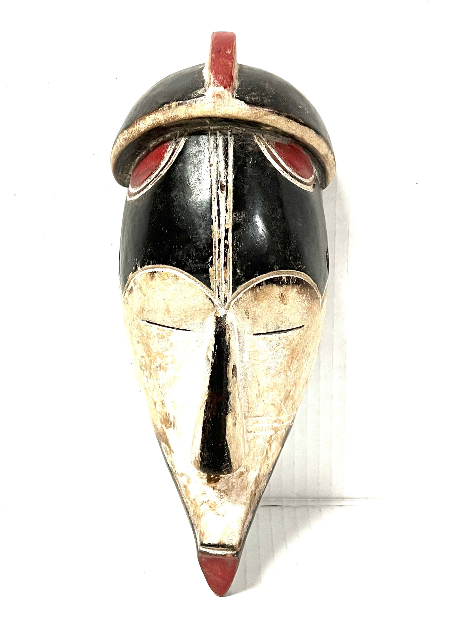 Fang Mask: Title: Fang Mask Description: African Tribal Art Carved Wood Fang Mask Materials: Wood Date/Period: Late 20th Century Size: 12" h x 5" w Reserve: $180.00 Shipping: Domestic: Flat-rate of $30.00 to