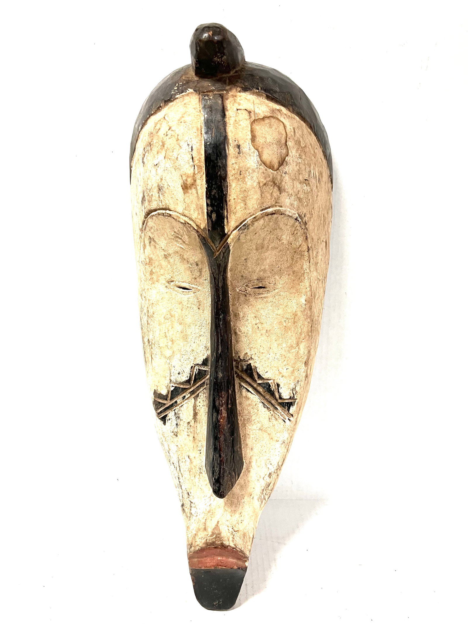 Fang Mask: Title: Fang Mask Description: African Tribal Art Carved Wood Fang Mask Materials: Wood Date/Period: Late 20th Century Size: 21.5" h x 8.75" w Reserve: $180.00 Shipping: Domestic: Flat-rate of $40.00