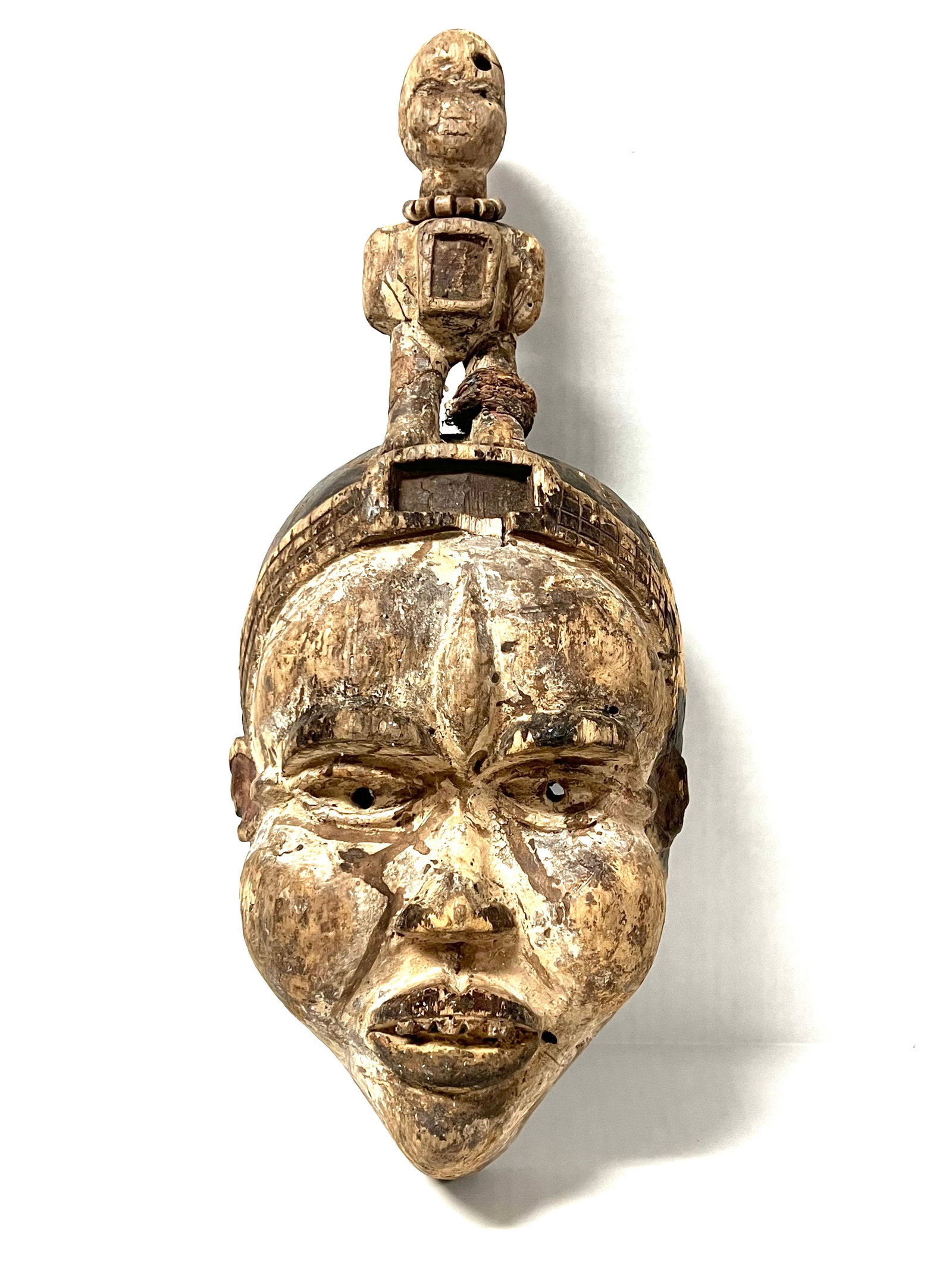 Bacongo Mask: Title: Bacongo Mask Description: African Tribal Art Carved Wood Bacongo Mask Materials: Wood Date/Period: Late 20th Century Size: 17' h x 7.5" w Reserve: $200.00 Shipping: Domestic: Flat-rate of
