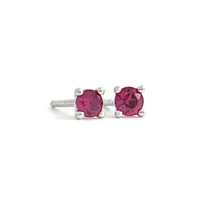 Small Round Ruby Gemstone Stud Earrings 14K White Gold, .16 CTW: Small Round Ruby Gemstone Stud Earrings 14K White Gold, .16 CTW Gemstones: 2 round rubies .16 ctw Metal: 14K white gold Weight: .55 grams Stamped: 14K Measurements: 2.8 mm x 2.8 mm Backs: push backs