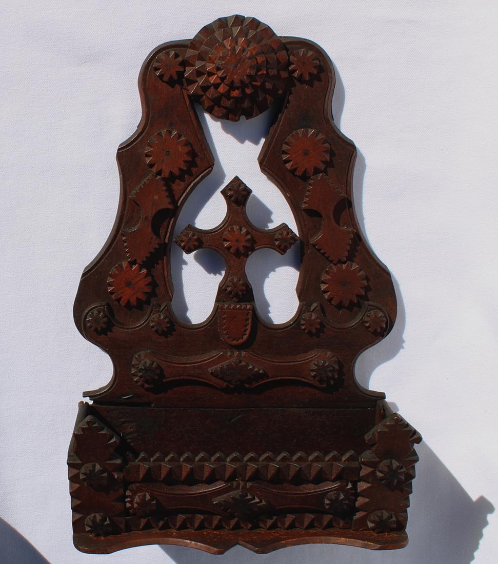 A tramp art wall box. Very fine workmanship and designs.: This is a tramp art wall box. It has very fine workmanship and free form designs. It has a dark, rich surface with slight color variation in the woods used. A folded piece of cloth was tacked to the