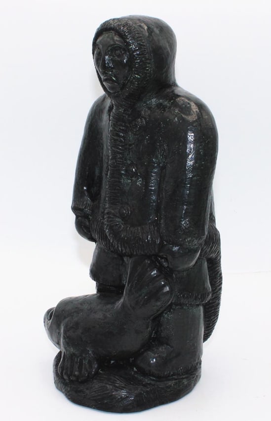 A Native Alaskan stone carving of a man and a seal. - 2