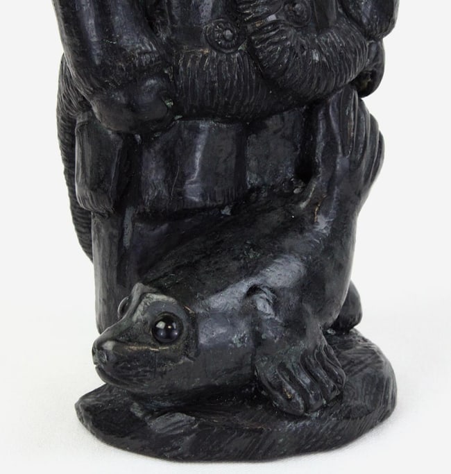 A Native Alaskan stone carving of a man and a seal. - 5