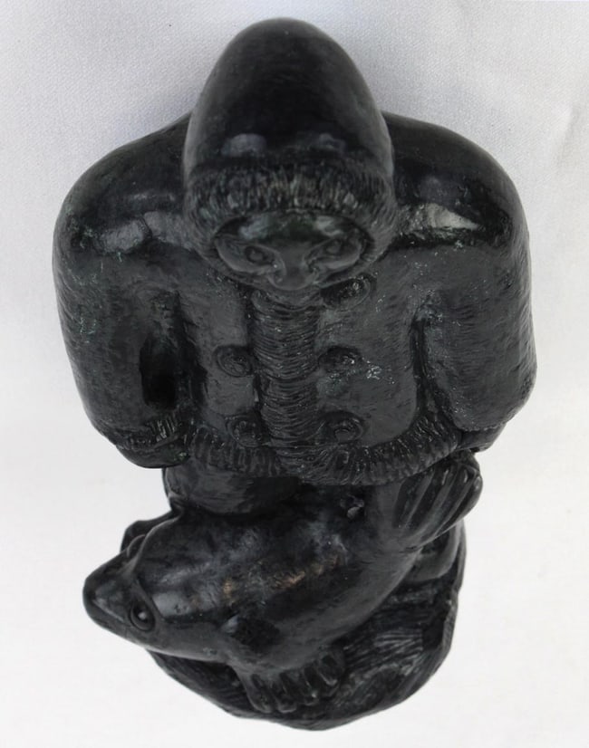 A Native Alaskan stone carving of a man and a seal. - 7