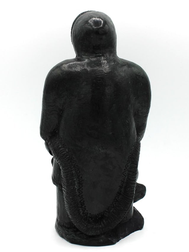 A Native Alaskan stone carving of a man and a seal. - 9