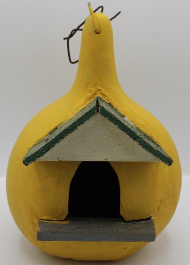 Unusual painted birdhouse built of wood set into a gourd.: A nicely painted birdhouse built of wood set into a gourd. It has a wire loop for hanging, and drainage holes drilled in the bottom. From the second half of the 20th c., in used, weathered condition