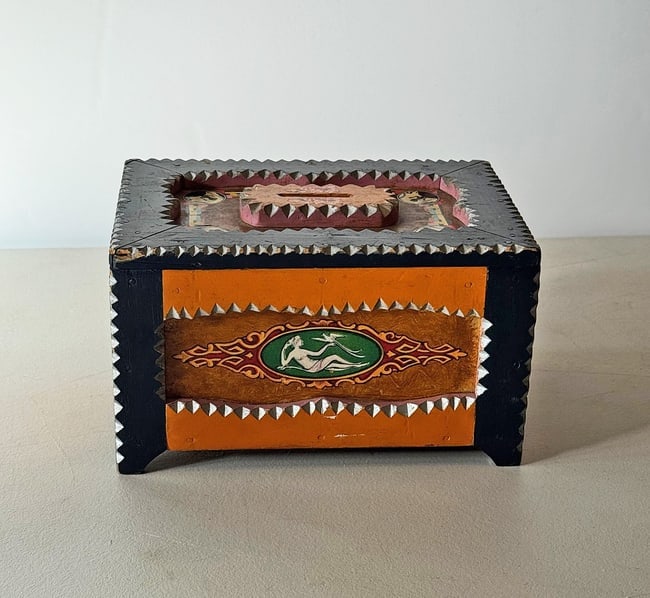 Colorful Painted Tramp Art Bank with Slot for Coins: No Reserve! A colorful painted tramp art bank with a slot for coins on its top. Applied Art Deco decals further embellish each side and top. The bottom has a metal hatch to open and access the coins.