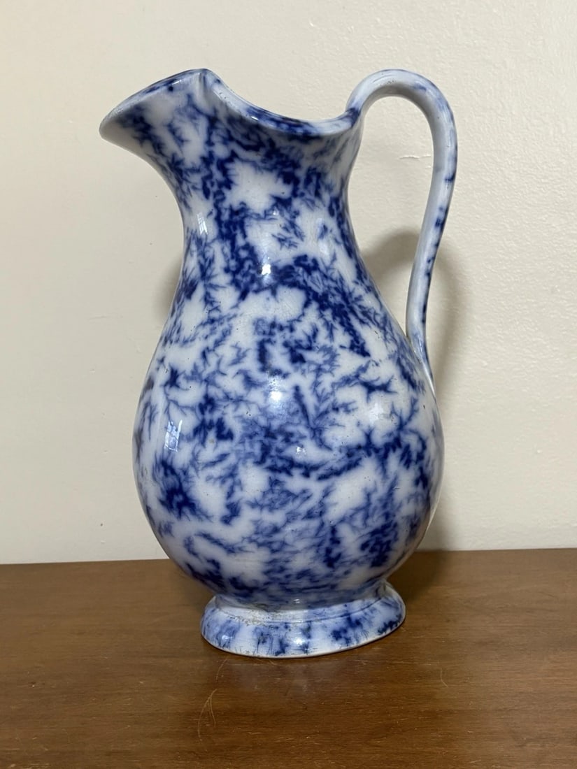 Marble Flow Blue Pitcher: It is 12 1/2" high and dates around the 1850's. It has a small flake on the top rim, a small spot of discoloration and three craze lines that do not go through. Otherwise it has no other issues. It