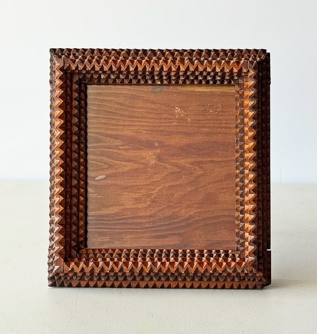 Tramp Art Tabletop Frame w Glass: Tramp Art Frame with its original glass. It has a homemade stand to use a tabletop frame, or it could be hung on the wall. The frame is thick and well-built and has its original wavy glass. It is in