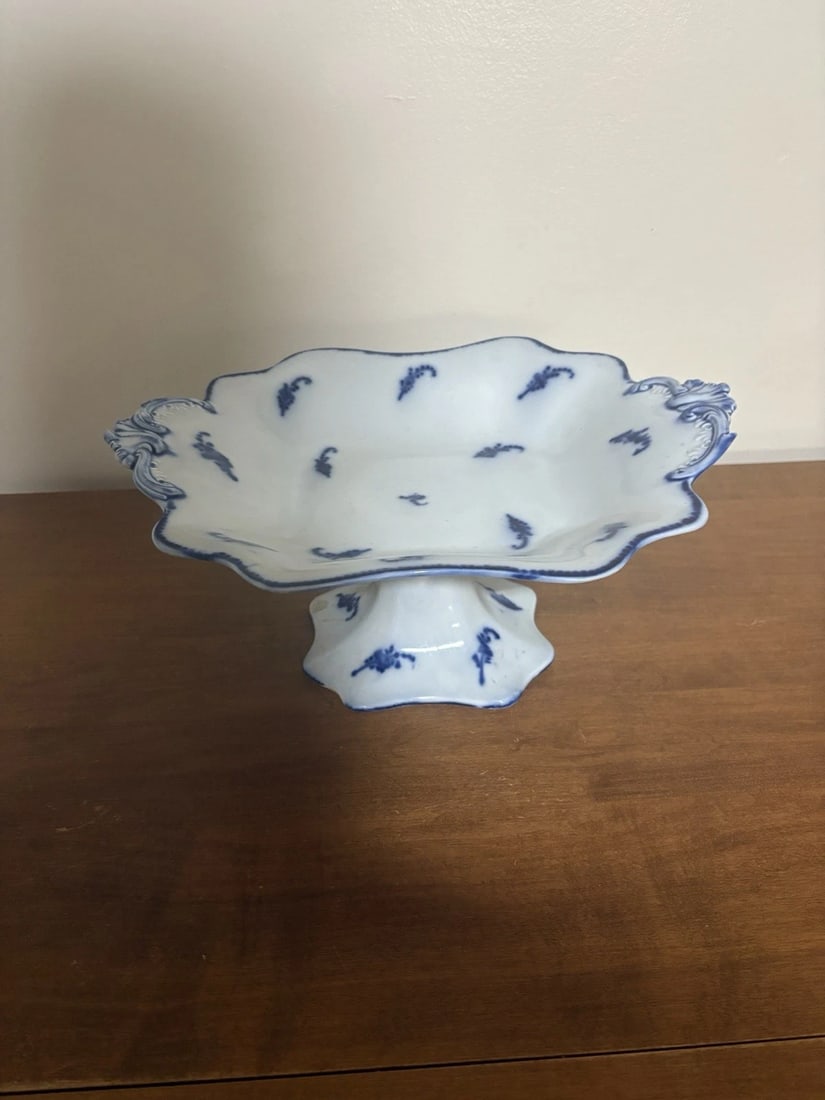 Flow Blue Compote: It measures 13 1/8" x 10 1/8" x 6 1/4" and dates around the 1860's. It has a chip on the base rim. Otherwise it has no other issues. Shipping: Domestic: Flat-rate of $15.00 to anywhere within the
