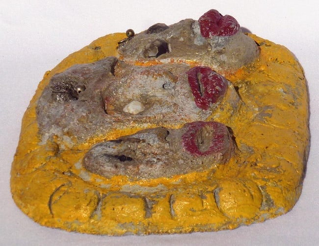 A concrete folk - outsider art plaque by Betty Davis: 3 women's faces - 2