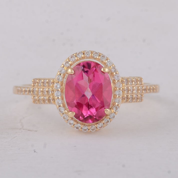 1.86 Ct Oval Pink Topaz 9K Gold Ring: 1.86 Total Carat Pink Topaz 9K Gold Ring Specifications: Total Weight 2 g Center Gemstone Pink Topaz Gemstone Carat Weight 1.59 Carats Gemstone Measurements 8X6 mm Additional Gemstones White Sapphire 