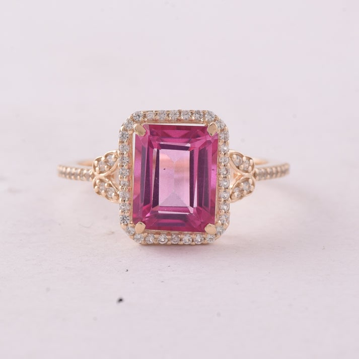 3.49 Ct Octagon Pink Topaz 9K Gold Ring: 3.49 Total Carat Pink Topaz 9K Gold Ring Specifications: Total Weight 2.339 g Center Gemstone Pink Topaz Gemstone Carat Weight 3.24 Carats Gemstone Measurements 9X7 mm Additional Gemstones White