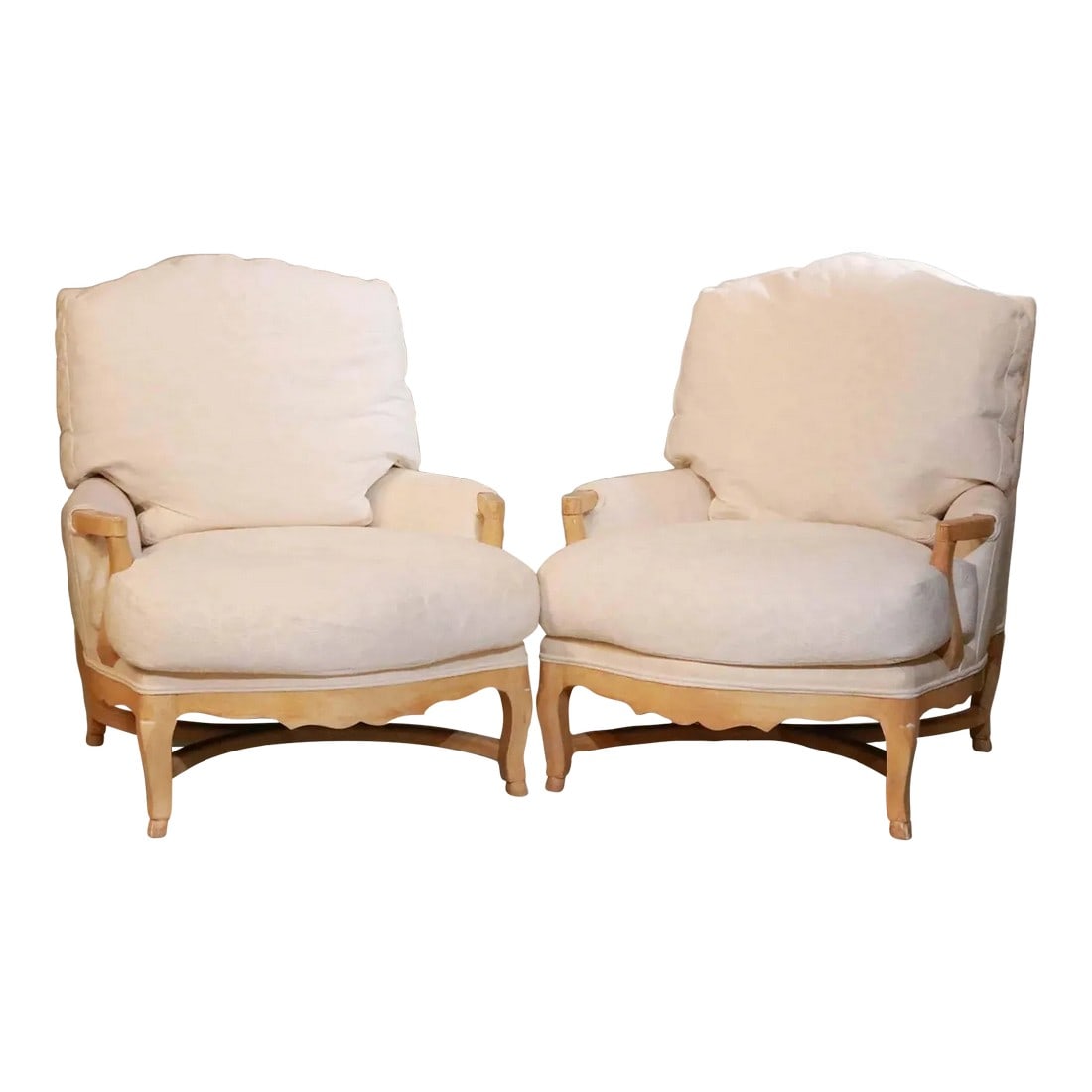 Pair of Late 20th Century Pickled Oak Bergere Chairs: Very stylish pair of Louis XV style oversized pickled oak bergere chairs. Extremely comfortable. The fabric is original and shows slight discoloration so will most likely need to be changed.