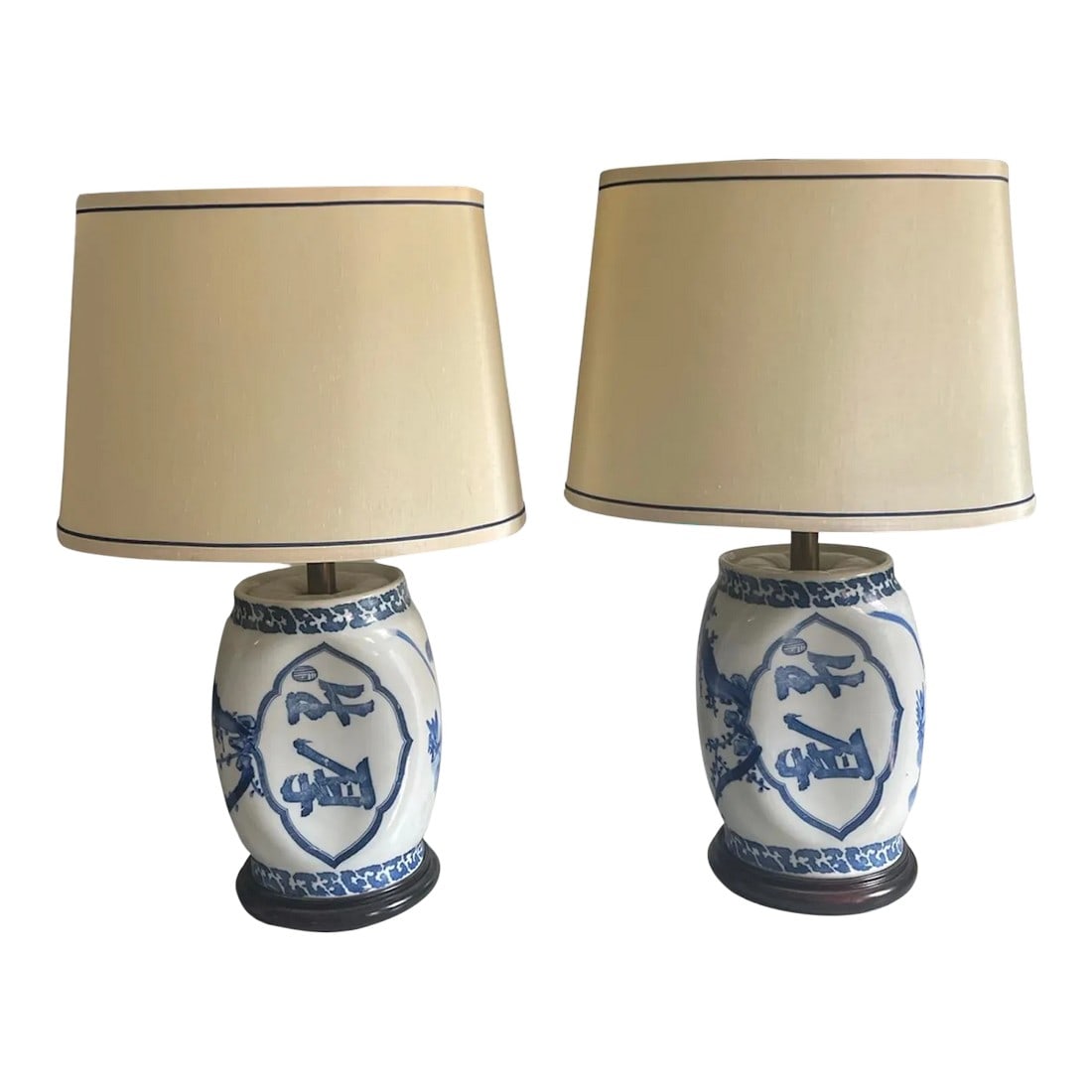 Vintage Blue and White Lamp Set With Original Shades - a Pair: A pair of Chinese porcelain blue and white opium pillow lamps with calligraphy and foliate decoration resting on carved wooden bases. Circa 1900. Original silk shades with blue piping included. Shade