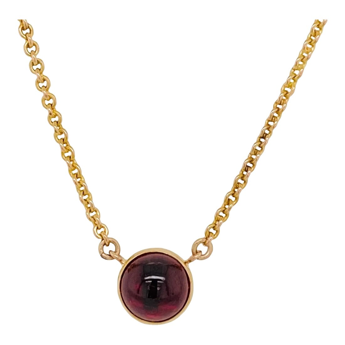 Antique 14k Gold Cabochon Garnet Pendant Necklace: This is part of Chairish's Fine Jewelry assortment. This is a beautiful bezel set cabochon garnet pendant on a 14K gold chain. The back of the pendant is marked 14K. It dates from the turn of the