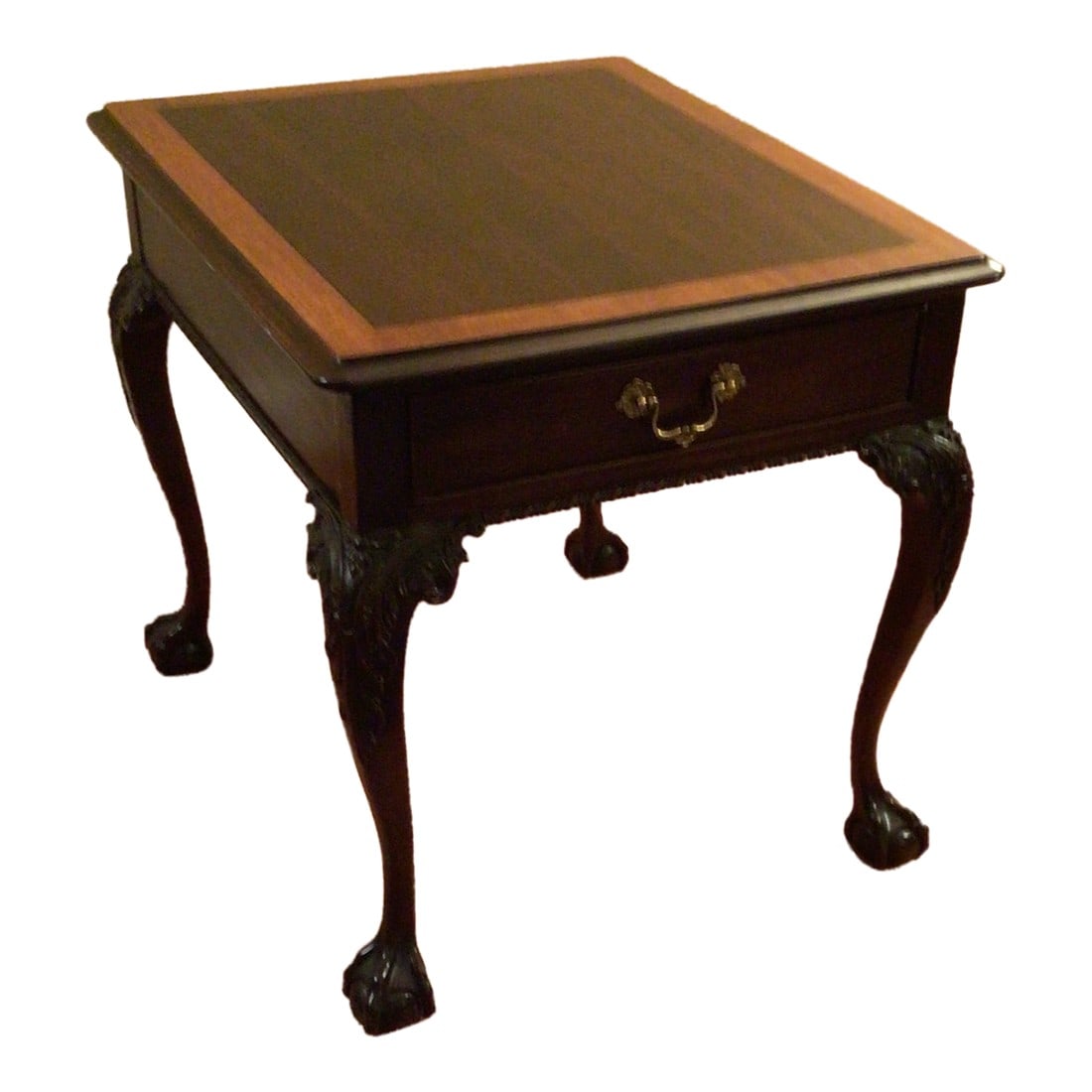 1990s Stickley Mahogany Ball and Claw End Table: Executed in solid mahogany in the 1990s by Stickley, this table features a warm brown, satin gloss finish with ebony inlay and contrast border. The top has a molded ogee edge. Underneath is an apron w
