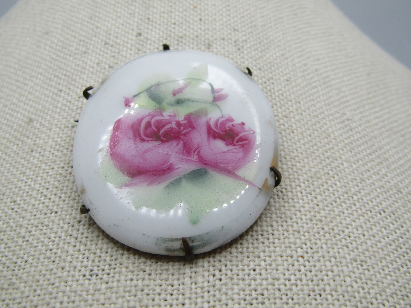 Victorian Floral Painted Brooch, Cameo Style, Late 1800's: Victorian Floral Painted Brooch, Cameo Style, Late 1800's. C -clasp with a pin that extends slightly beyond the frame of the brooch. Painted porcelain pink rose blossoms (or peonies) with buds and gre