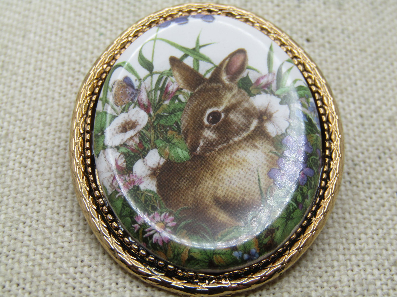 Vintage Rabbit Cameo Spring/Summer Brooch, 1960's-1970's: Vintage Rabbit Cameo Style Spring/Summer Brooch, 1960's-1970's. Very cute rabbit sitting among the spring or summer flowers looking cute as ever. Gold tone frame and appx. 1-7/8" tall and 1.5" in an o