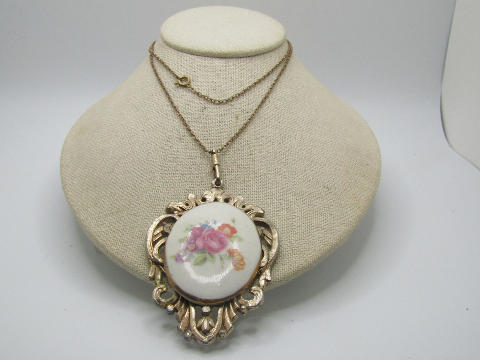 Vintage Floral Cameo Style Necklace, 26": Vintage Floral Cameo Style Necklace, 26". Pink roses and other flowers , like decal transfer on porcelain that is glazed with a gold leaf trim. The cameo portion is appx. 2" by 1.5". It is set on a