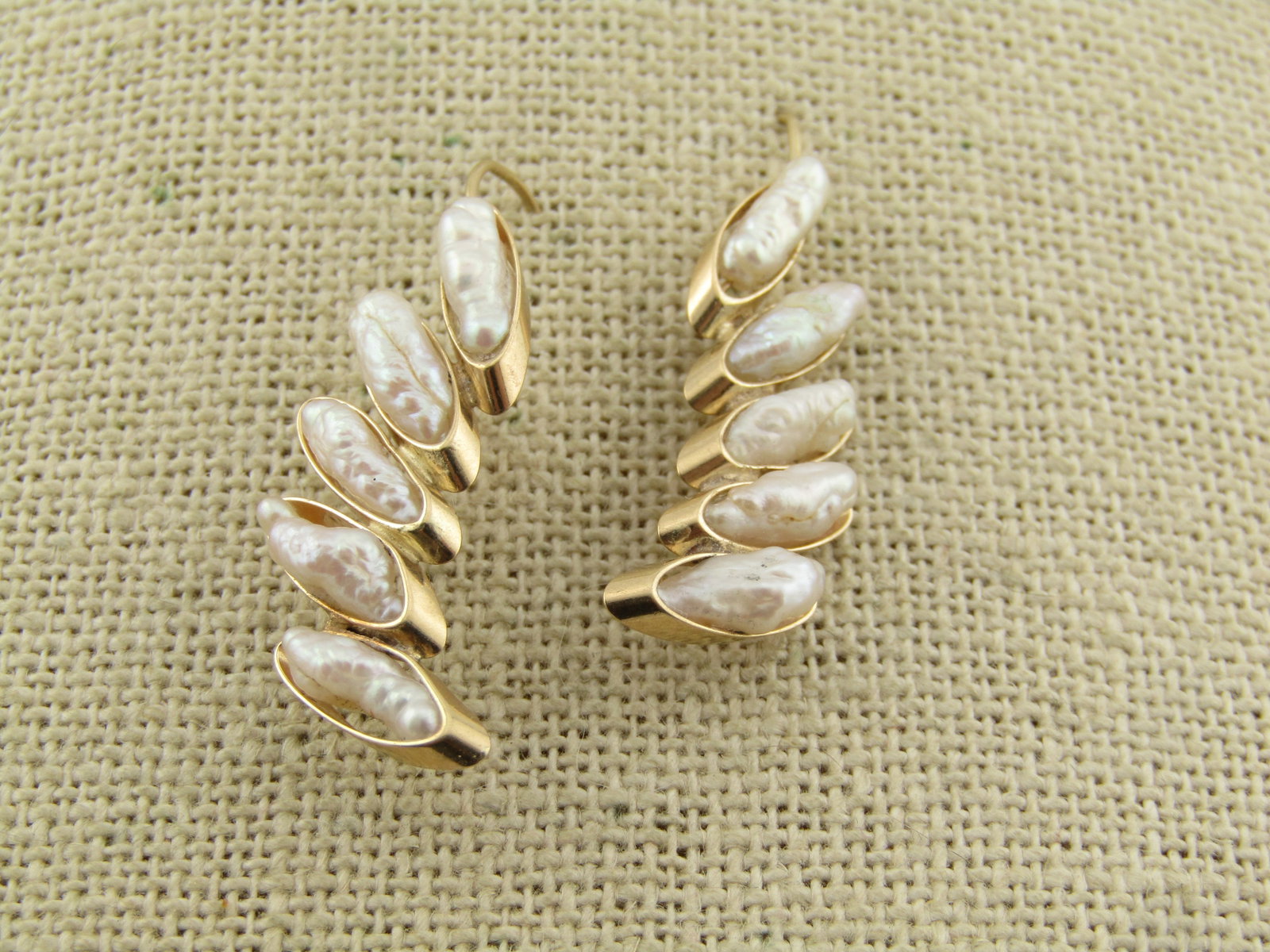 Vintage 14kt Freswater Pearl Stacked Earrings, 1970's-1980's: Vintage 14kt Freswater Pearl Stacked Earrings, 1970's-1980's. There are five freshwater eparls set inside a 14kt gold bezel, stacked in a slight curved design. The earrings are appx. 10mm wide at the