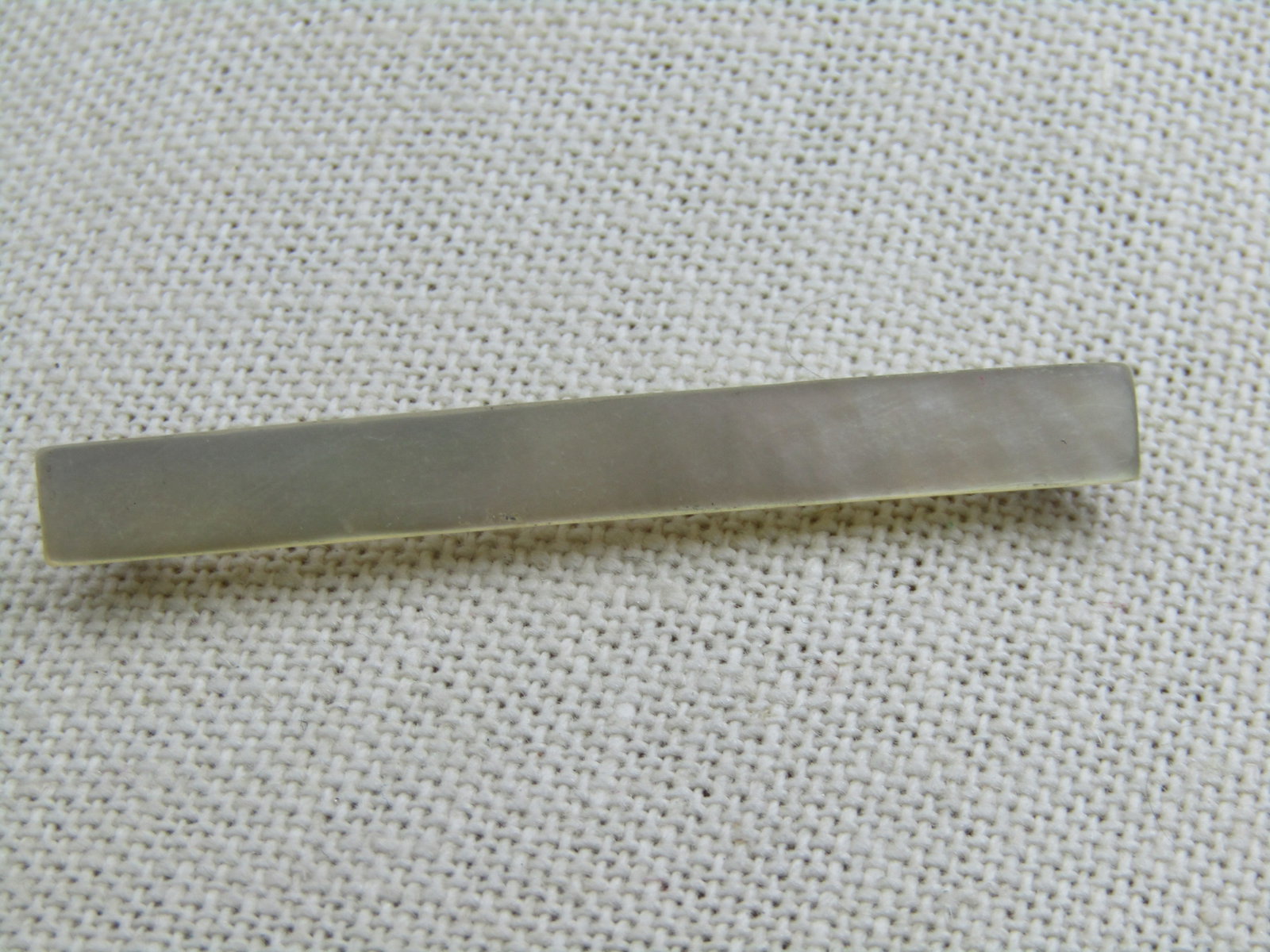 Victorian Mother-of-Pearl Bar Brooch, 2-1/8" wide: Victorian Mother-of-Pearl Bar Brooch, 2-1/8" wide and .25" tall. Late 1800's to 1910. Pin extends sightly beyond the frame of the brooch, C-Clasp. Not signed by maker. (INV. W.11.219.5.AD.12.13)