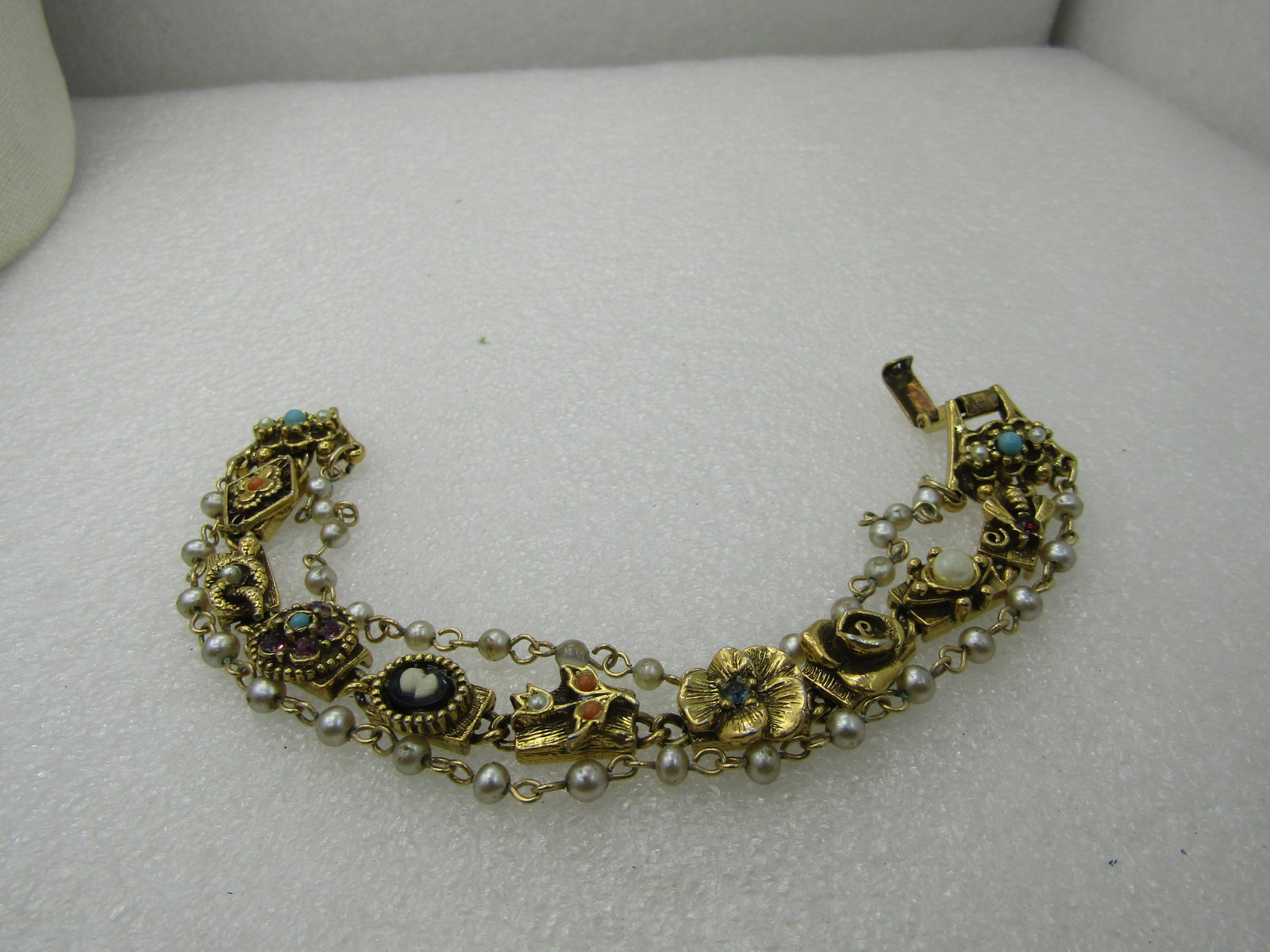 Vintage Victorian Themed Triple Strand Faux Pearl, Charm Link Bracelet, 7", 1960's: Vintage Triple Strand Faux Pearl, Victorian themed link bracelet, alhambra, snake with faux pearl, rhinestone floral, cameo, pansy, rose, and others. Bracelet, 7", 1960's. This has a faux pearl strand
