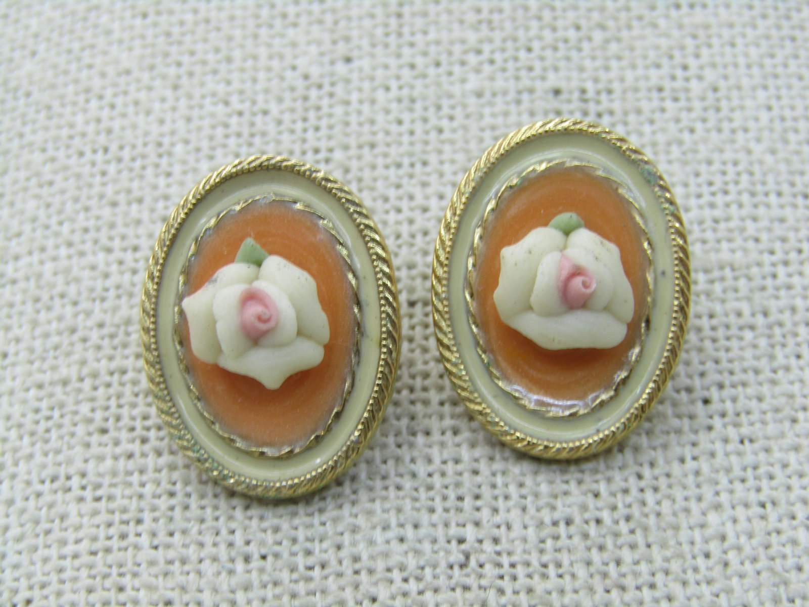 Vintage Porcelain Rose Cameo Pierced Earrings, 7/8" Oval, Gold Tone: Vintage Porcelain Rose Cameo Pierced Earrings, 7/8" by 5/8" Oval, Gold Tone. Filigree frame with orange swirled enameled base and a raised porcelain rose with pink center. Pierced. Not signed.