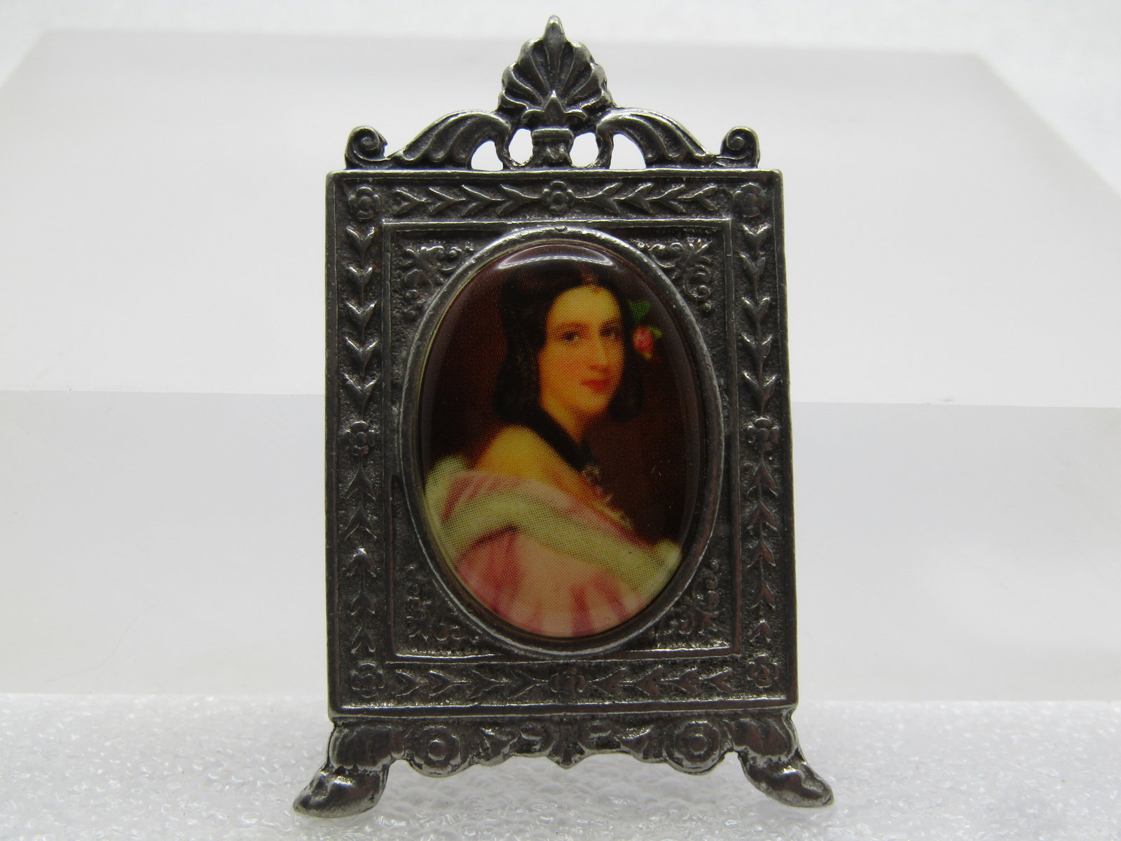 Vintage Faux Painted Cameo Brooch in Photo Frame Setting, 1970's: Vintage Faux Painted Cameo Brooch in Photo Frame Setting, 1970's. This is a pewter or silver tone frame with flowers and other design on a footed frame design with a center oval raised faux painted