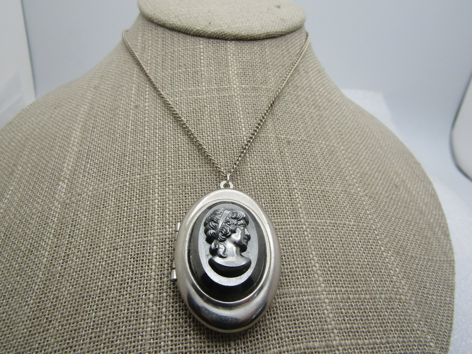 Vintage Hematite Cameo Locket Necklace, 18" , 1960's: Vintage Hematite Cameo Locket Necklace, 18" , 1960's. Very clean silver tone locket with a hematite raised cameo on the front, hinged on the left and will hold two photos inside. The locket is appx. 1