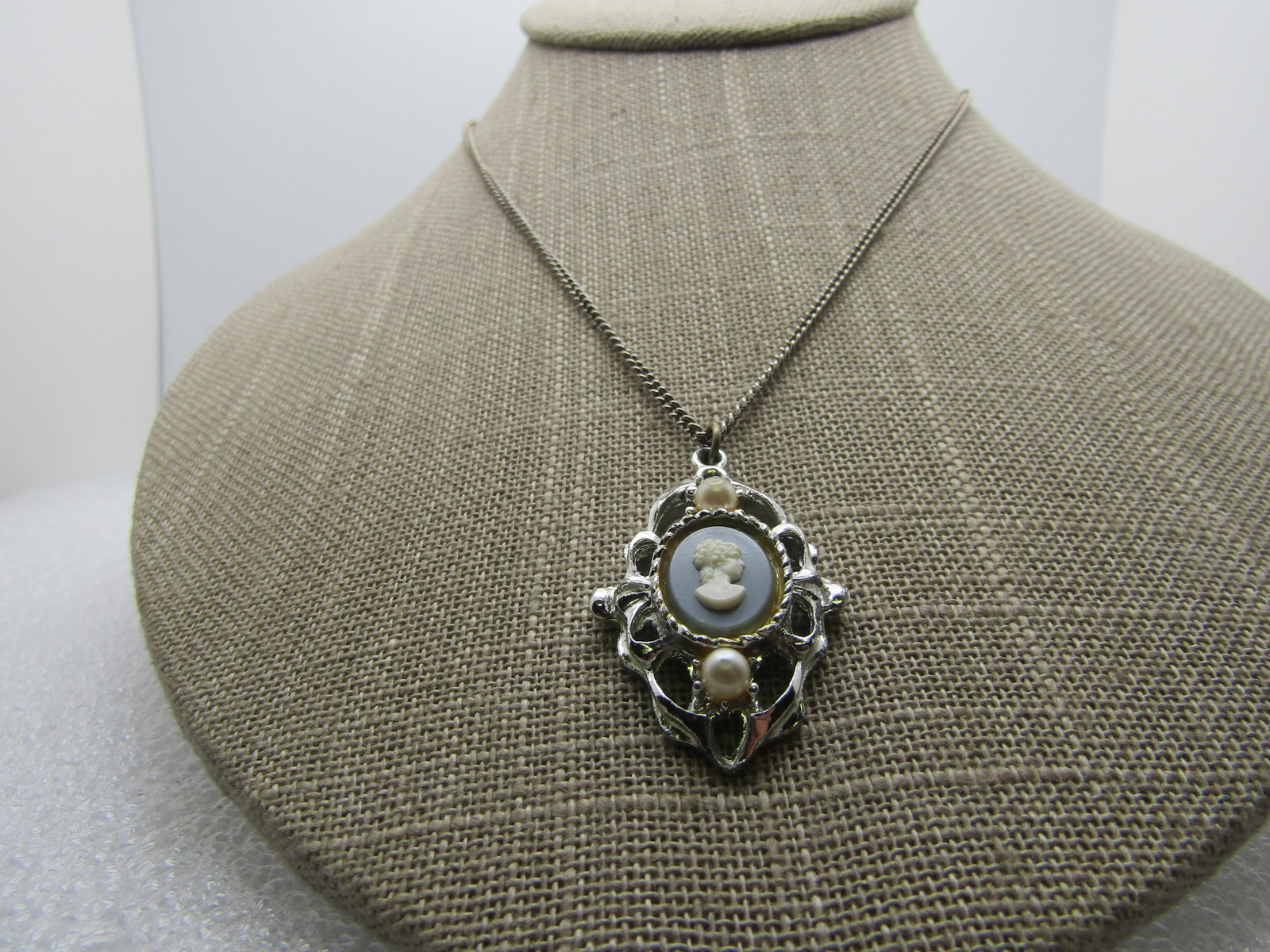 Vintage Cameo Faux Pearl Necklace, 16", 1960's: Vintage Cameo Faux Pearl Necklace, 16", 1960's. The pendant has a faux Wedgwood cameo set in a s iler tone pendant with a faux pearl above and below the cameo. The pendant is appx. 1.5" by nearly 1" w