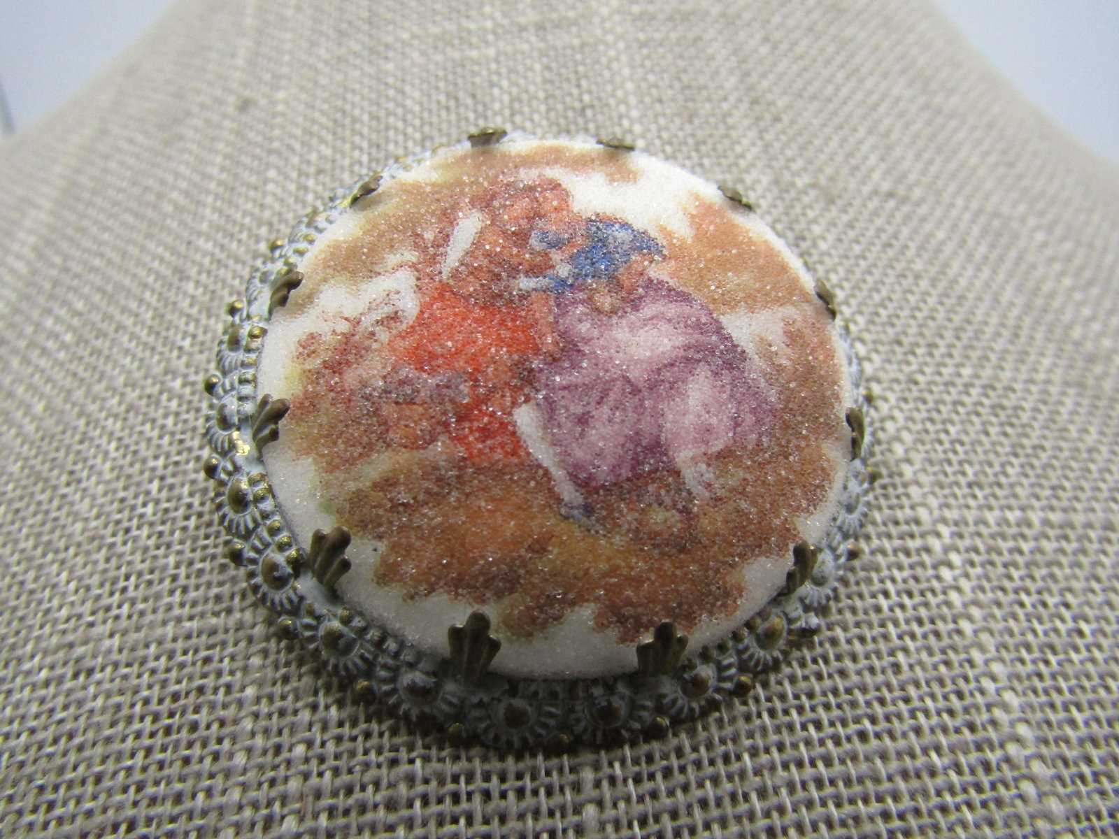 Vintage Courting Scene Sugar Cameo Brooch, 1950's: Vintage Courting Scene Sugar Cameo Brooch, 1950's. this is a white washed blossom framed courting scene brooch with fleur-de-lis style prongs holding the 35mm round courting scene with a sugar finish 