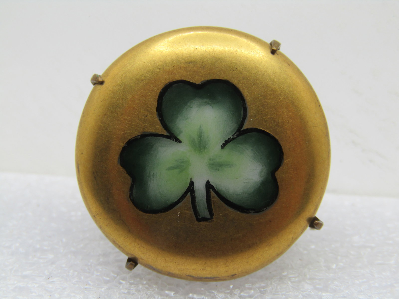 Antique Porcelain Three-Leaf Clover Brooch, 1910-1920's, C-Clasp: Antique Porcelain Three-Leaf Clover Brooch, 1910-1920's, C-Clasp/ Mounted in a cameo style with four prongs. Gold painted background with shaded three-leaf clover on top. it is appx. 1" round. Very go