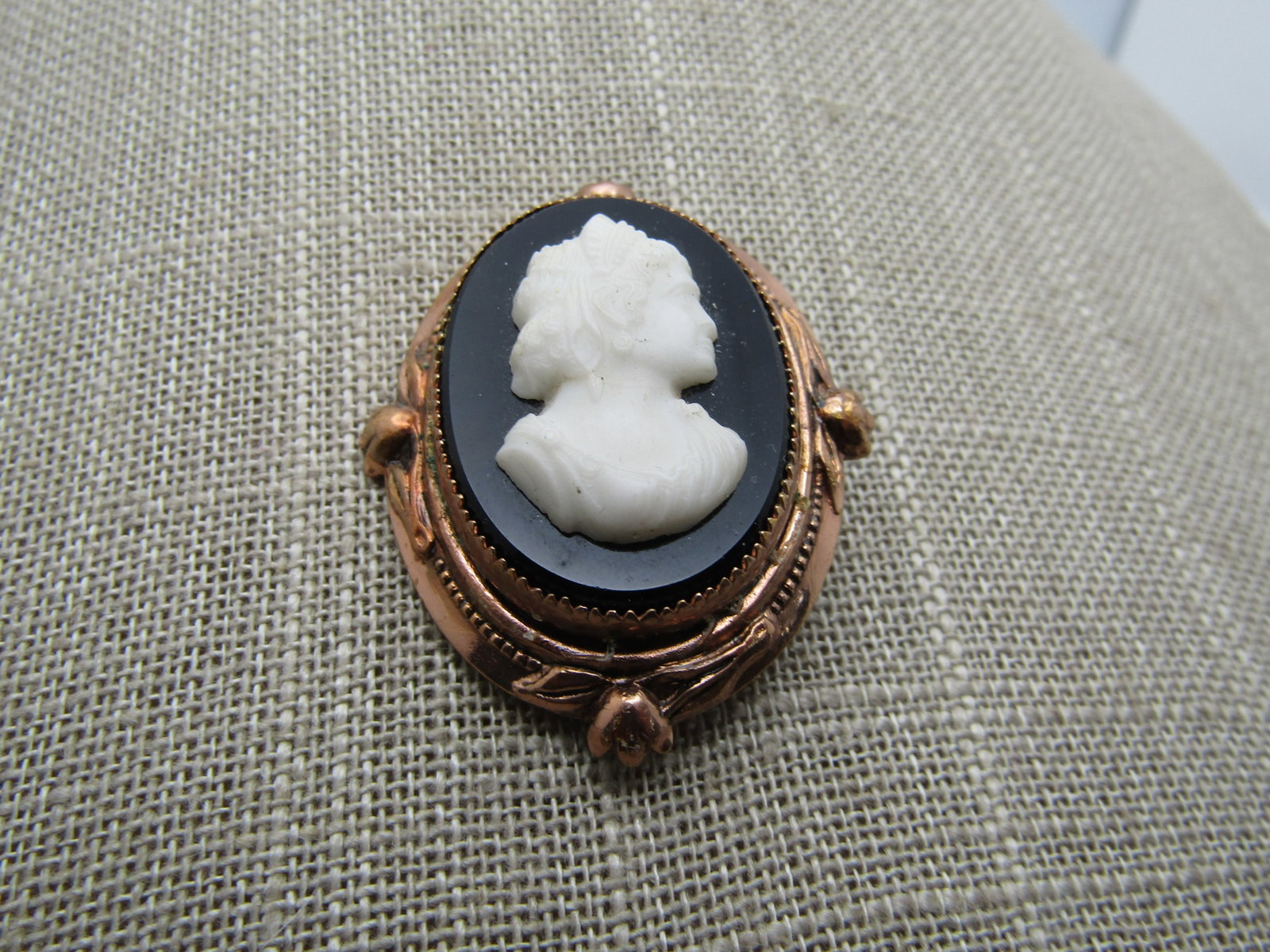 Vintage Black & White Cameo Brooch, Coro, Rose Gold Tone, 1940's, 1.75": Vintage Black & White Cameo Brooch, Coro, Rose Gold Tone, 1940's, 1.75" tall and 1.5" wide. The metal is rose gold tone with a black oval glass and white glass cameo - oval at appx. 1.25" tall and 7/8