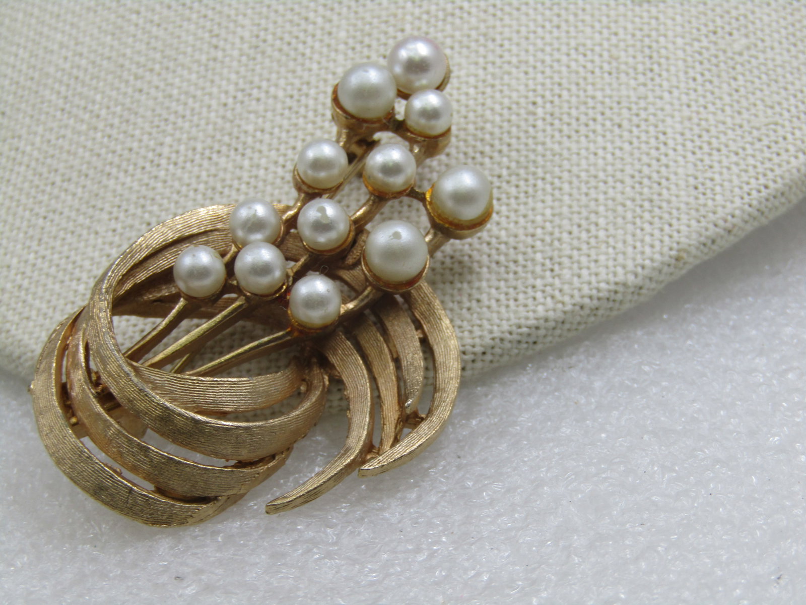 Vintage Faux Pearl Curved Brooch, 1960's, 2.25": Vintage Faux Pearl Curved Brooch, 1960's, 2.25" tall and appx. 1.25" wide. Gold Tone, textured and smooth finish. This has floral like stems coming out of the textured curved petals. It is not