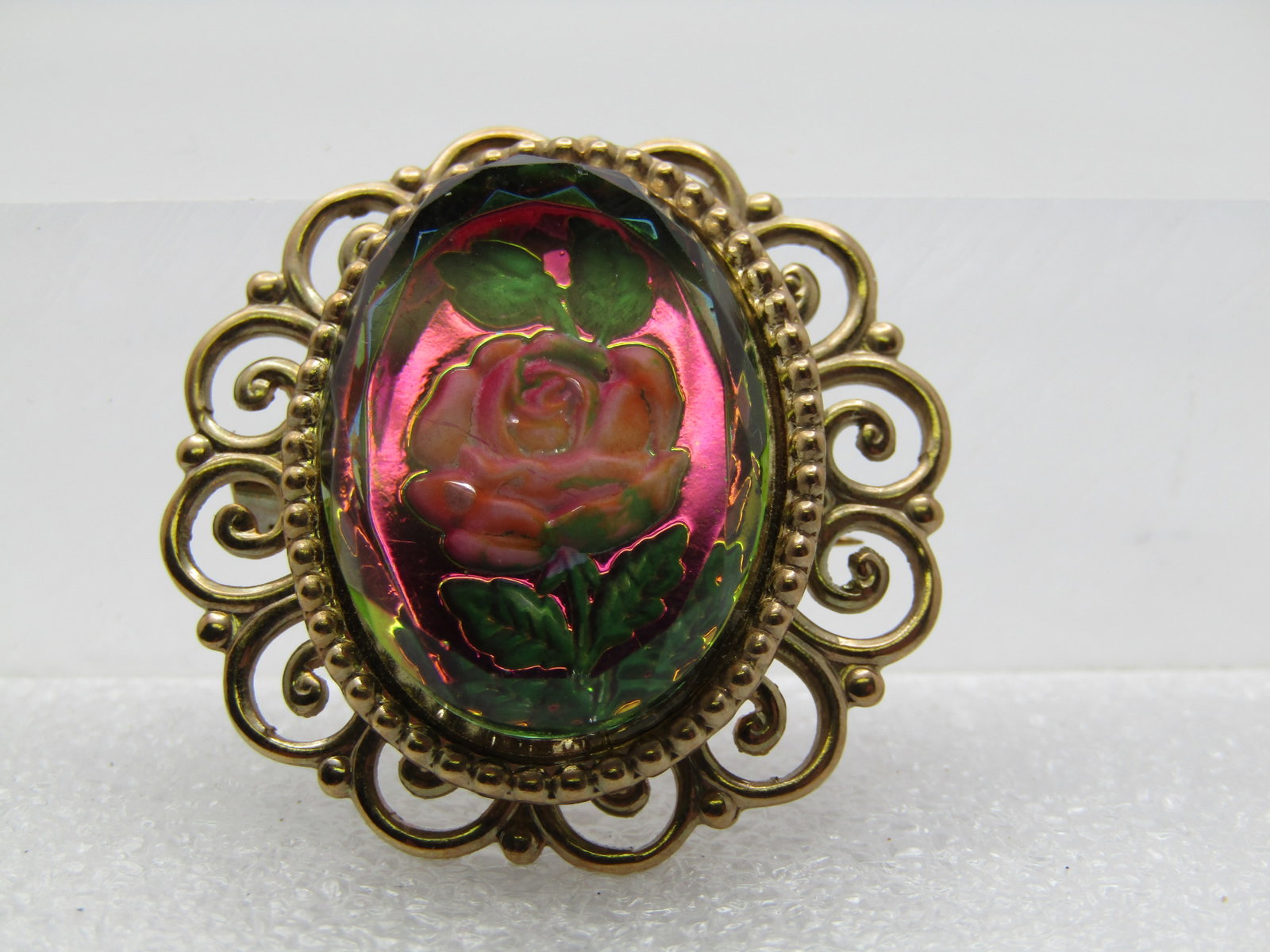 Vintage Reverse Rose Brooch, Cameo Style, 1950's-1960's: Vintage Reverse Rose Brooch, Cameo Style, 1950's-1960's. Stamped rose and leaves into the back of a molded ore pressed rose into the clear acrylic with a magenta iridescent background, pink rose and g