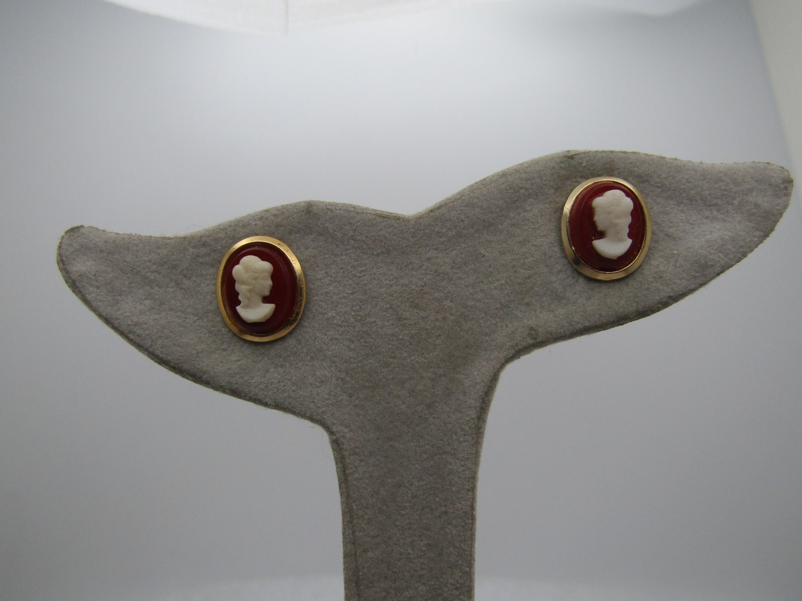 Vintage Cameo Pierced Earrings, 1960's-1970's: Vintage Cameo Pierced Earrings, 1960's-1970's. Appx. 1/2" tall and slightly less wide with molded plastic carnelian colored and w hite cameos. Gold tone. Costume. Not signed by the maker. Very clean a