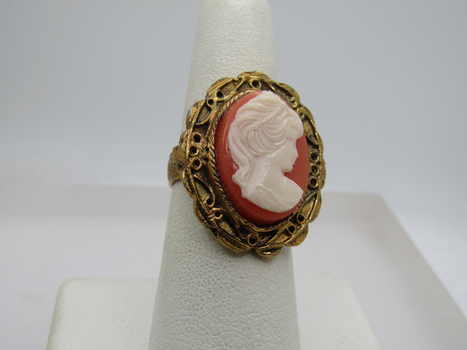 Vintage Cameo Ring, Sz. 6-8 Adjustable, 1960's-1970's: Vintage Cameo Ring, Sz. 6-8 Adjustable, 1960's-1970's. Butterscotch and white plastic molded cameo that is appxc. 3/4" by 1/2" wide. Scrolled wider frame, scrolls are raised. The ring is appx. 1-1/8" 