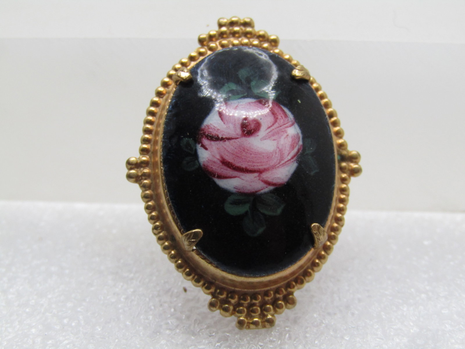 Vintage Rose Painted Black Glass Cameo Style Brooch, 1950's-1960's: Vintage Rose Painted BlackCameo Style Brooch, 1950's-1960's. This appears to be a glazed black porcelain base with a painted pink rose with white background and green leaves. It is domed and the rose 