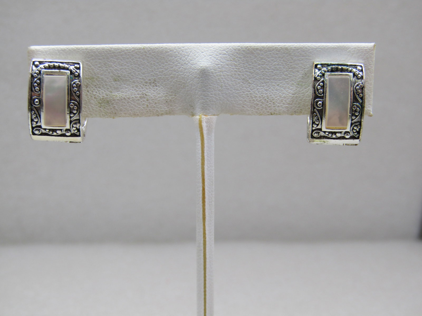 Monet Mother-of-Pearl Hoop Magnetic Clip Earrings, 5/8" Long: Monet Mother-of-Pearl Hoop Magnetic Clip Earrings, 5/8" Long and 1/2" wide with an inlaid MOP rectangle down the front and a scrolled faux marcasite-like look on the front. Silver tone. Appx. 1990's. 