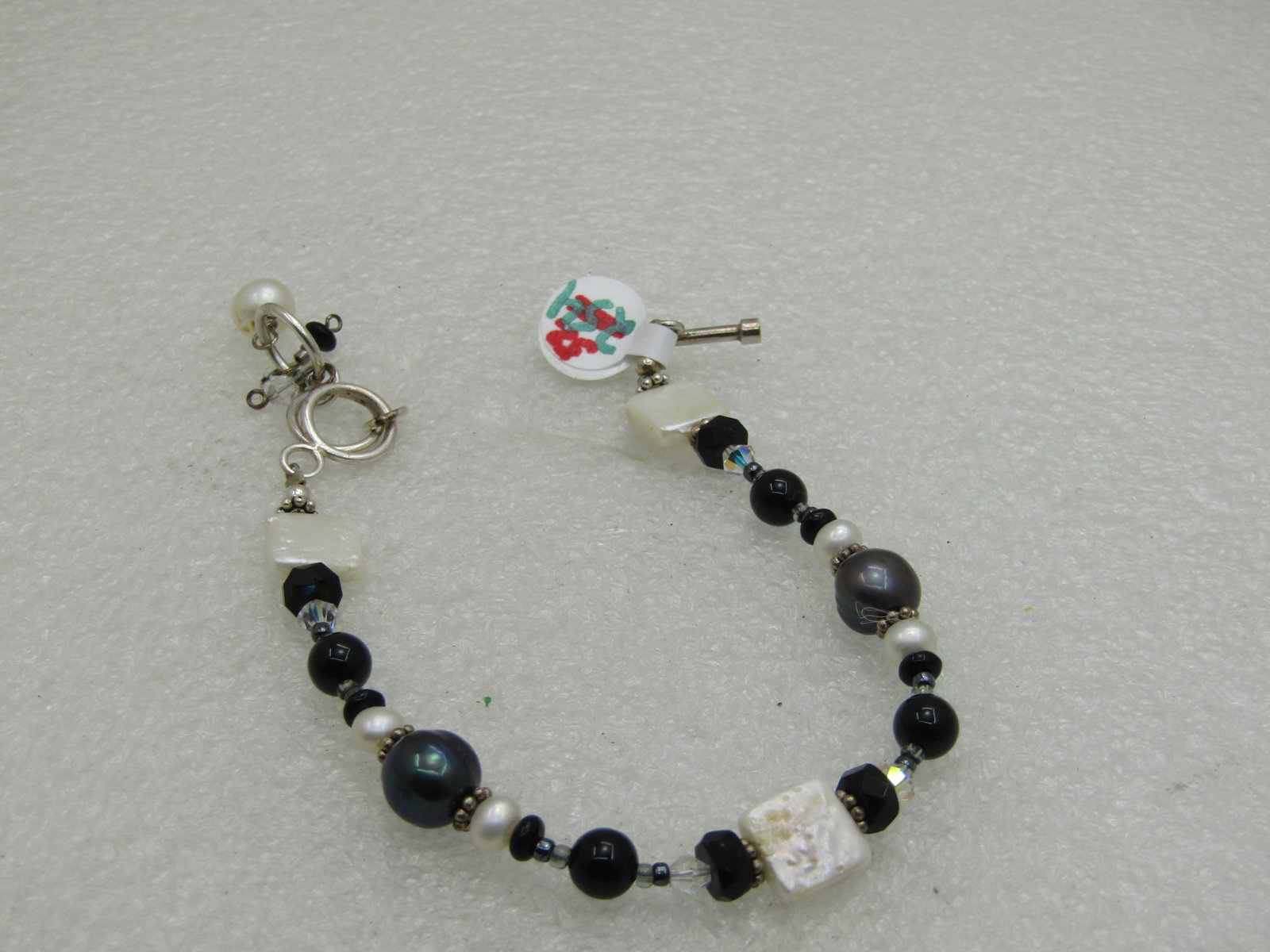 Sterling Silver Tahitian Pearl Bracelet with Freshwater Pearls, 8, Adjustable: Sterling Silver Tahitian Pearl Bracelet with freshwater pearls, 8" long with a few rings for the toggle to adjust shorter with a dangle if desired. Dark Tahitian baroque style pearls with black glass 