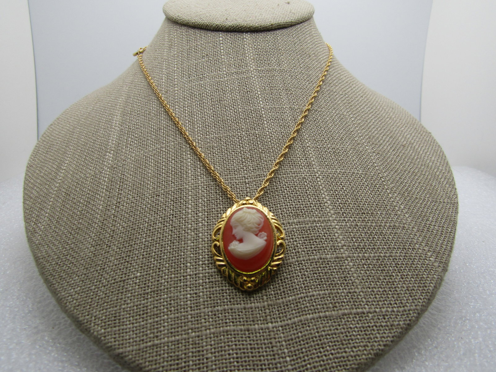 Vintage Cameo Necklace, 1960's-1970's, Gold Tone, 23.5": Vintage Cameo Necklace, 1960's-1970's, Gold Tone, 23.5". Unsigned. The pendant is appx. 1-1/8" long and 3/4" wide. The bail is built in to the back of the pendant. This has a 2mm wide rope chain with