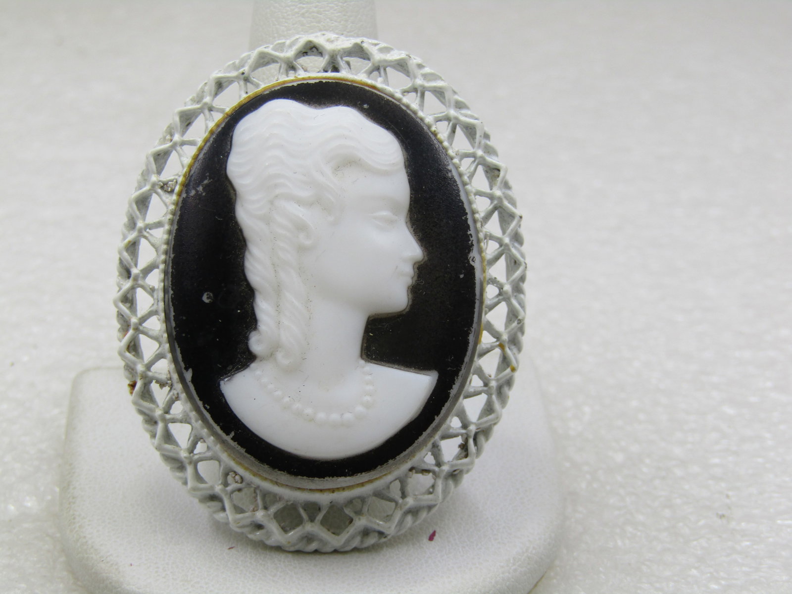Vintage White Enameled Cameo Brooch/Pendant, 2", 1940's-1950's: Vintage White Enameled Cameo Brooch/Pendant, 2", 1940's-1950's. Black and white glass cameo bezel-set in the frame. This was not set evenly as the lower edge sits higher out of the bezel than the uppe