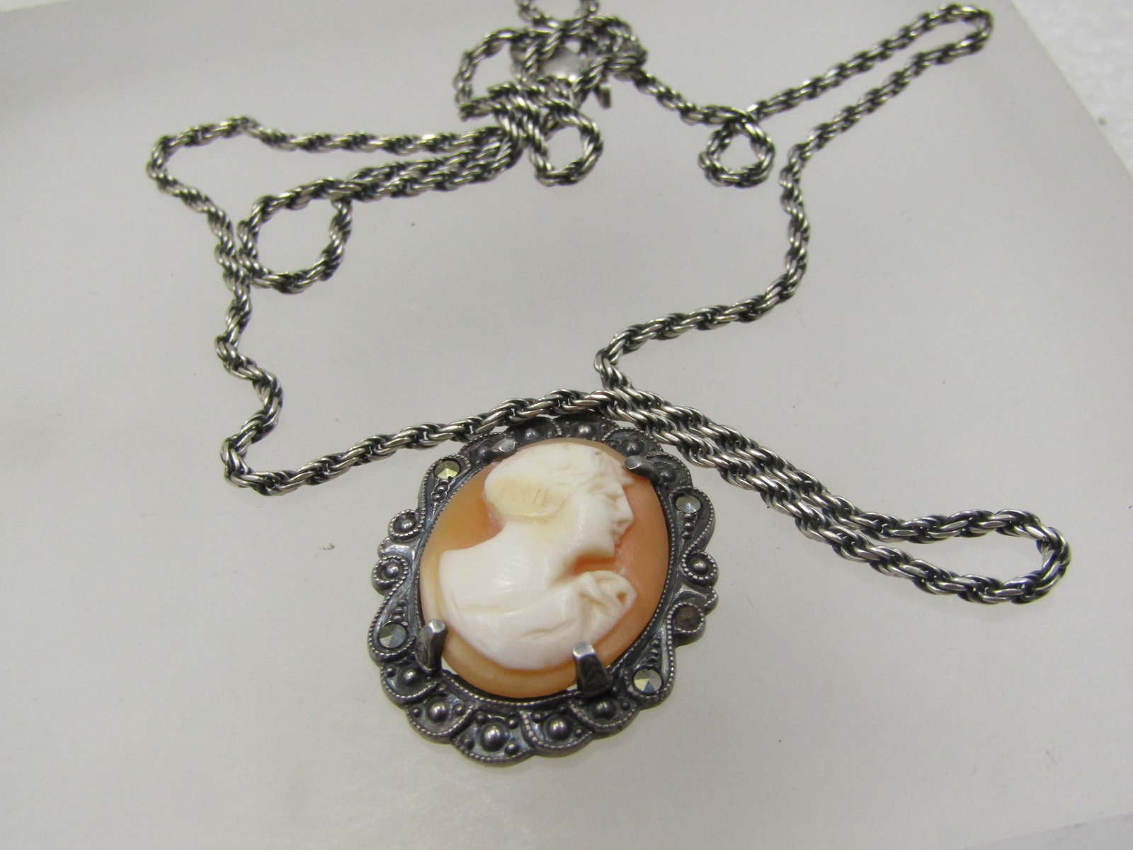 Vintage Sterling Marcasite Cameo Necklace, 21" Rope Chain: Vintage Sterling Marcasite Cameo Necklace, 21" Rope Chain. The chain is appx. 2mm wide, twisted rop chain that is newer than the cameo pendant which is appx. 1930's-1940's. One marcasite was missing
